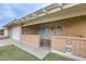 Charming entrance featuring brick accents and a covered walkway, leading to the front door at 10816 W Hatcher Rd, Sun City, AZ 85351