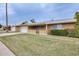 Well-kept single-Gathering home featuring a lush front lawn, attached garage, and welcoming facade at 10816 W Hatcher Rd, Sun City, AZ 85351