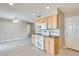 Cozy kitchen with tile flooring, modern appliances, and adjacent living area at 10816 W Hatcher Rd, Sun City, AZ 85351