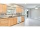 Stylish kitchen with tile floor, double sink, and sliding glass doors to the patio at 10816 W Hatcher Rd, Sun City, AZ 85351