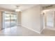 Bright living room with tile flooring, ceiling fan, and access to an outdoor patio at 10816 W Hatcher Rd, Sun City, AZ 85351