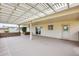 Covered patio featuring a brick wall, concrete floor, and sliding glass door at 10816 W Hatcher Rd, Sun City, AZ 85351