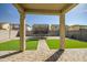 View of backyard from covered patio features turf and paver stones, trampoline at 10823 W Polk St, Avondale, AZ 85323