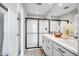 Well-appointed bathroom features a glass-enclosed shower, double sink vanity, and stylish fixtures at 10823 W Polk St, Avondale, AZ 85323