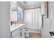 Bright bathroom features a white vanity with black hardware and tile flooring at 10823 W Polk St, Avondale, AZ 85323