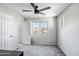 Neutral bedroom with gray carpet, ceiling fan and large window for natural light at 10823 W Polk St, Avondale, AZ 85323