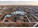 Resort-style community pool with modern sunshades, playground and covered picnic tables at 10823 W Polk St, Avondale, AZ 85323