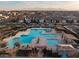 Aerial view of large community pool with lounge chairs, sunshades and splash area at 10823 W Polk St, Avondale, AZ 85323