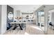 Spacious dining area leading into a modern white kitchen with sleek appliances and countertop dining at 10823 W Polk St, Avondale, AZ 85323