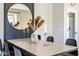 Bright dining room with modern decor, statement mirror, and light-filled space perfect for gatherings at 10823 W Polk St, Avondale, AZ 85323