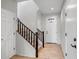 Inviting entryway features neutral tile flooring, a staircase with wood banister, and natural light at 10823 W Polk St, Avondale, AZ 85323