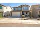 Exterior shot of a two-story home with a front-facing garage and desert landscaping at 10823 W Polk St, Avondale, AZ 85323