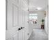 Bright upstairs hallway featuring two doors, a window, and a decorative stool creates an inviting space at 10823 W Polk St, Avondale, AZ 85323