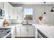 Bright kitchen with white cabinets, stainless steel appliances, and quartz countertops at 10823 W Polk St, Avondale, AZ 85323