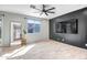 Bright living room featuring a large window, hardwood floors, a modern ceiling fan and neutral walls at 10823 W Polk St, Avondale, AZ 85323