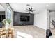 Bright living room featuring neutral walls, modern ceiling fan and tiled floors at 10823 W Polk St, Avondale, AZ 85323