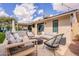 A backyard featuring an outdoor seating area with a fire pit and a view of the sliding glass door at 10903 E Sahuaro Dr, Scottsdale, AZ 85259