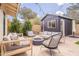 A backyard featuring an outdoor seating area with a fire pit and a view of the black storage shed at 10903 E Sahuaro Dr, Scottsdale, AZ 85259