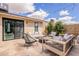 A backyard featuring an outdoor seating area with a fire pit and a view of the sliding glass door at 10903 E Sahuaro Dr, Scottsdale, AZ 85259