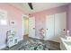 Charming Bedroom showcasing light pink walls, a cozy rug, and white closet doors, providing a warm and inviting atmosphere at 10903 E Sahuaro Dr, Scottsdale, AZ 85259