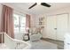 Bright Bedroom featuring soft pink walls, hardwood floors, and a comfortable chair, creating a serene atmosphere for relaxation at 10903 E Sahuaro Dr, Scottsdale, AZ 85259