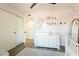 Well-lit Bedroom with white dresser, closet and changing table, providing a functional and organized space at 10903 E Sahuaro Dr, Scottsdale, AZ 85259