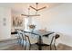 Inviting dining area with a stylish light fixture, comfortable seating, and an artistic painting on the wall at 10903 E Sahuaro Dr, Scottsdale, AZ 85259