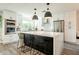 Bright kitchen with stainless steel appliances, a large island with seating, and modern white cabinets at 10903 E Sahuaro Dr, Scottsdale, AZ 85259