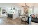 Bright, updated kitchen and dining area featuring an island with seating, stainless appliances, and modern design at 10903 E Sahuaro Dr, Scottsdale, AZ 85259