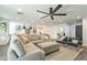 Bright, open-concept living room with a large sectional sofa, a view to the kitchen, and stylish seating area at 10903 E Sahuaro Dr, Scottsdale, AZ 85259