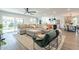 Open-concept living room featuring a large sectional sofa, modern ceiling fan and view into the modern kitchen at 10903 E Sahuaro Dr, Scottsdale, AZ 85259