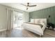 Serene main bedroom features an accent wall and a patio door leading to the backyard and outdoor dining at 10903 E Sahuaro Dr, Scottsdale, AZ 85259