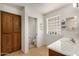 Bathroom with tiled floors, ample cabinet space and a glass block window at 11046 E Naranja Ave, Mesa, AZ 85209