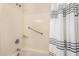 Shower with accessible handrail and white striped shower curtain at 11046 E Naranja Ave, Mesa, AZ 85209