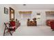 Bright living room showcasing neutral carpet, a large window, and a comfortable seating area at 11046 E Naranja Ave, Mesa, AZ 85209