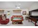 Inviting living room with bright accents, featuring a ceiling fan and comfortable seating at 11046 E Naranja Ave, Mesa, AZ 85209