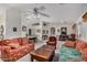 Spacious living room featuring a ceiling fan, neutral carpet, and an open layout for easy entertaining at 11046 E Naranja Ave, Mesa, AZ 85209