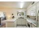 Bright kitchen with white cabinets, modern appliances, and a garden window at 1139 S 79Th St, Mesa, AZ 85208