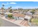 The aerial view displays the front yard, long driveway, and palm trees at 11430 N 57Th Dr, Glendale, AZ 85304