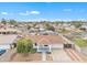 Aerial view showcases a single-story home with manicured landscaping and a spacious driveway at 11430 N 57Th Dr, Glendale, AZ 85304