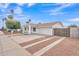 Front exterior of a bright white home with desert landscaping, covered entryway, and spacious driveway at 11430 N 57Th Dr, Glendale, AZ 85304