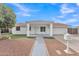 Charming single-story home featuring a covered porch, desert landscaping, and a well-maintained front yard at 11430 N 57Th Dr, Glendale, AZ 85304