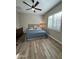 Bedroom featuring wood-look floors and a ceiling fan with a light fixture at 11612 W Candelilla Way, Peoria, AZ 85383