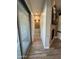 Hallway with wood plank flooring and access to the bathroom, closet, and sliding glass door to the exterior at 11612 W Candelilla Way, Peoria, AZ 85383