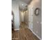 Hallway features wood-look tile flooring, neutral paint, and white doors at 11612 W Candelilla Way, Peoria, AZ 85383