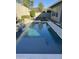 Swimming pool featuring waterfall and manicured landscaping with patio furniture in the background at 11612 W Candelilla Way, Peoria, AZ 85383