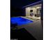 Relaxing view of a blue-lit swimming pool next to a covered patio area and outdoor furniture at dusk at 11612 W Candelilla Way, Peoria, AZ 85383