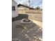 Backyard features a circular concrete patio with a stone fire pit and metal grate cover at 1172 E Delano Dr, Casa Grande, AZ 85122