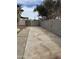 Long cement driveway with a gate and a concrete block wall in the backyard of a Gathering residence at 1172 E Delano Dr, Casa Grande, AZ 85122