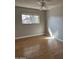 Bedroom with light colored walls, ceiling fan, window and wood-look laminate flooring at 1172 E Delano Dr, Casa Grande, AZ 85122